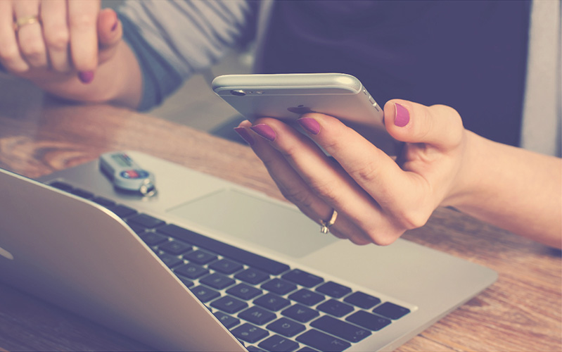 Woman holding phone - access management and multi-factor authentication