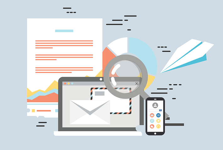 computer and magnified glass and cell phone with marketing related activities