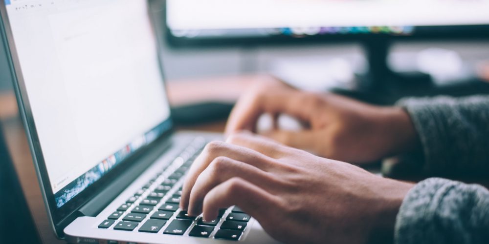 person typing on laptop