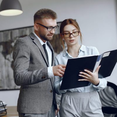Woman with glasses.Businessman with documents.Colleagues work together
